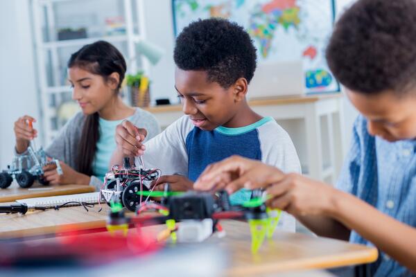 Youth working with robots